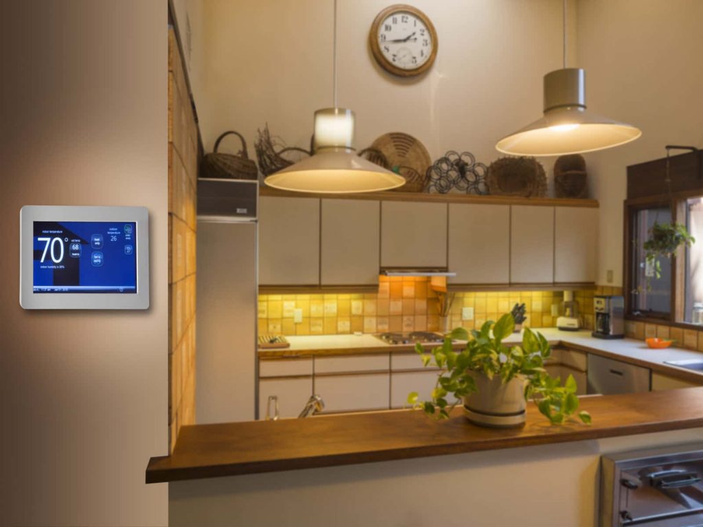 A smart thermostat in a kitchen.