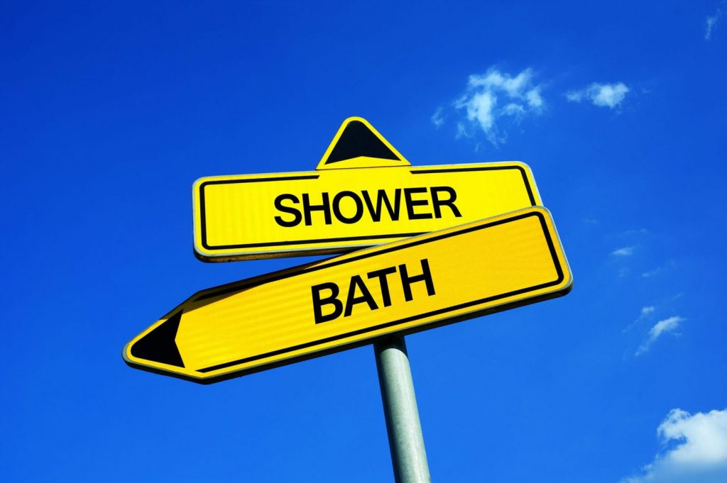 A road sign with Baths vs Showers and their arrows pointing in different directions.