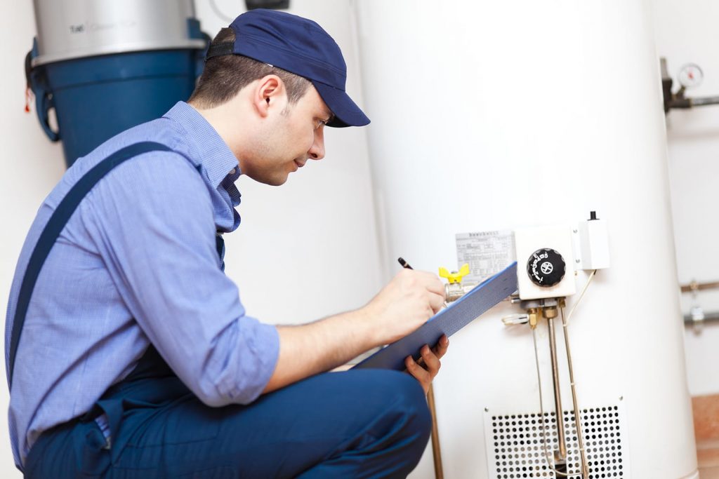 Prevent water heater failure with a checkup by a Sunrise expert. A plumber checks the gauges on a water heater