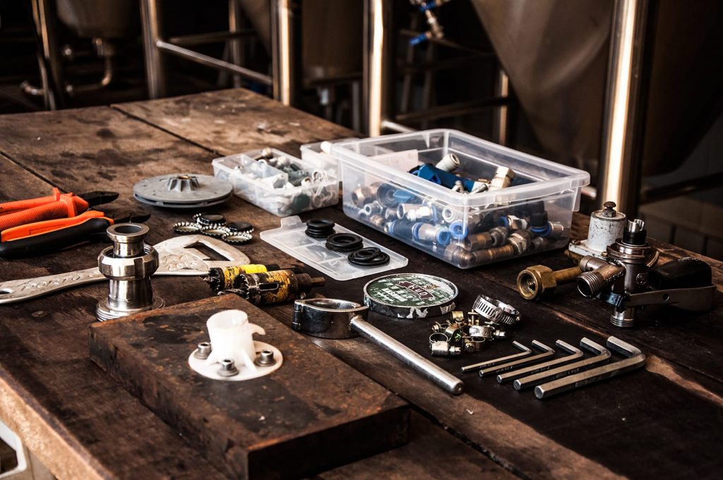 An array of various parts for plumbing systems on a work table.