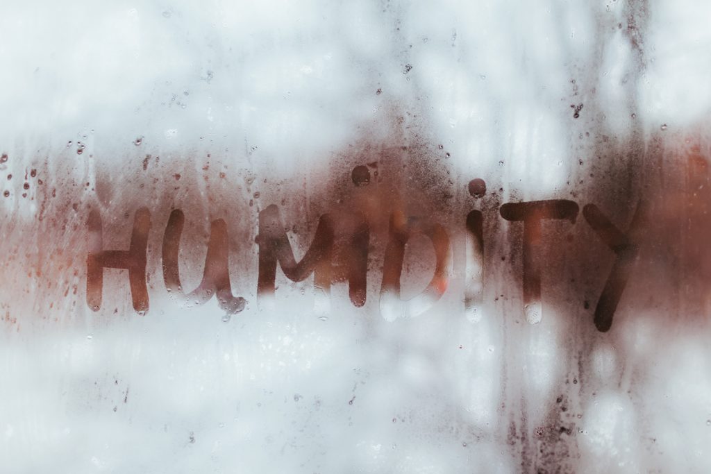 Don't let house humidity in winter leave you feeling dry when you need it most. Humidity spelled out in a fogged up window.