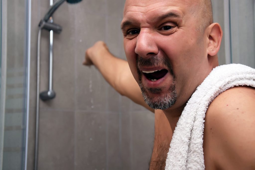 The look of terror on a man's face as he's realizing he's running out of hot water while he's putting a hand in the shower to test the water temp.